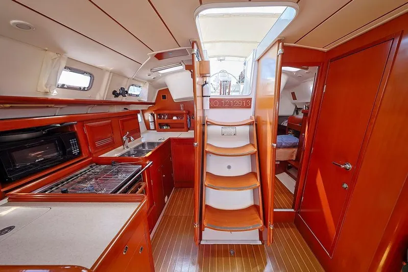 Mustang III Yacht Photos Pics Interior of 2007 Beneteau Oceanis 423 yacht, featuring a well-equipped kitchen and wooden cabinetry.