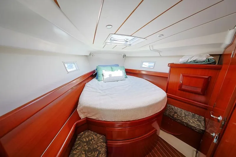 Mustang III Yacht Photos Pics Luxurious cabin interior of 2007 Beneteau Oceanis 423 yacht with cozy bed and wooden finish.