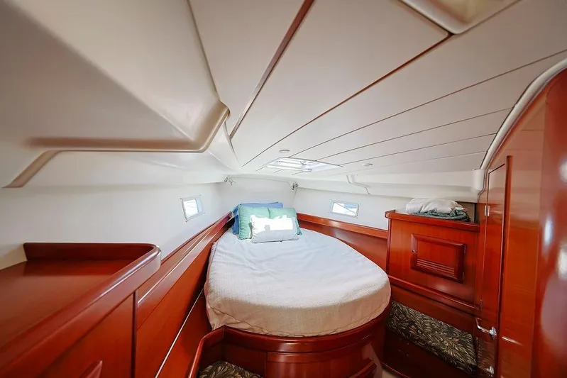 Mustang III Yacht Photos Pics Cozy cabin interior of 2007 Beneteau Oceanis 423 sailboat with wood finish and porthole windows.