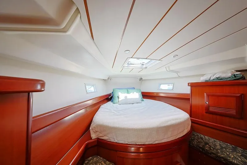 Mustang III Yacht Photos Pics Luxurious cabin interior of 2007 Beneteau Oceanis 423 sailboat with cozy bed and wooden finish.