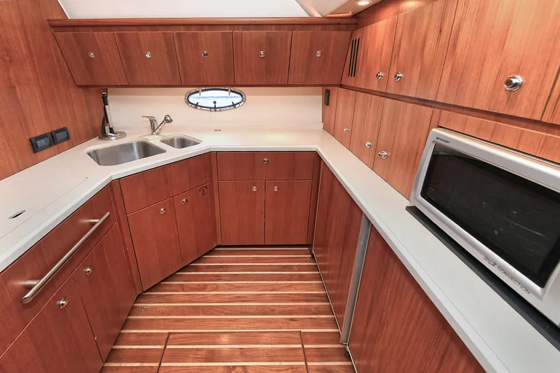 Spirit Yacht Photos Pics 2008 Tiara Yachts 4200 Open kitchen with wood cabinetry, stainless steel sink, and microwave.