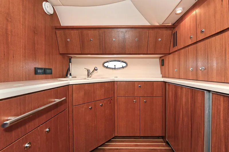 Spirit Yacht Photos Pics Luxurious wooden interior of 2008 Tiara Yachts 4200 Open, featuring ample cabinetry and sleek design.
