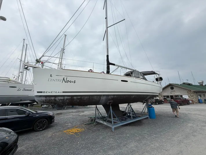  Yacht Photos Pics 2012 Beneteau Oceanis 37 sailboat on dry dock, overcast sky, marina setting.