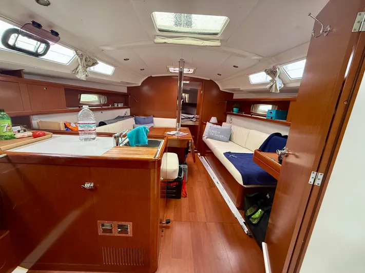  Yacht Photos Pics Interior of 2012 Beneteau Oceanis 37 sailboat with wood finish and cozy seating area.