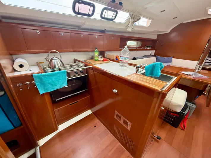  Yacht Photos Pics Interior of 2012 Beneteau Oceanis 37 sailboat, featuring a compact kitchen and dining area.