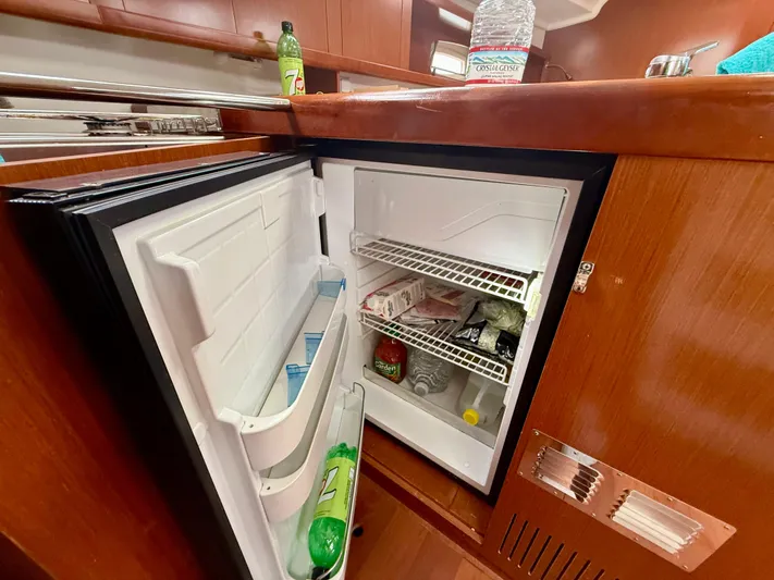  Yacht Photos Pics Open fridge in 2012 Beneteau Oceanis 37 yacht kitchen, stocked with beverages and food.
