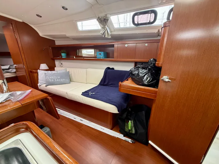  Yacht Photos Pics Interior of 2012 Beneteau Oceanis 37 sailboat with cozy seating and wooden finishes.