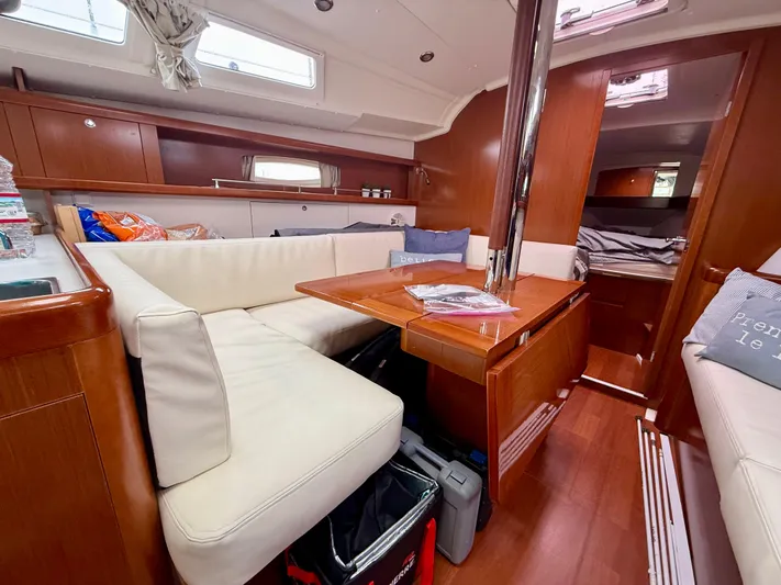  Yacht Photos Pics Interior of 2012 Beneteau Oceanis 37 sailboat with cozy seating and wooden finishes.