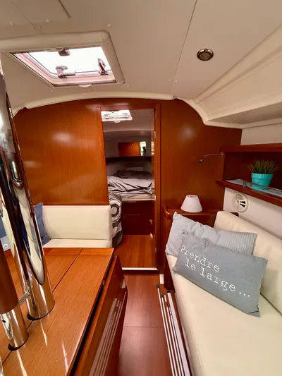  Yacht Photos Pics Interior of 2012 Beneteau Oceanis 37 sailboat with cozy seating and wooden finishes.