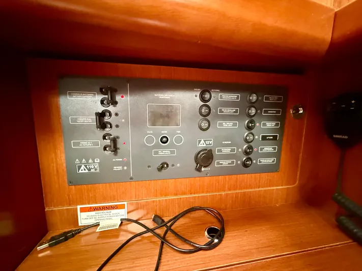  Yacht Photos Pics Control panel of a 2012 Beneteau Oceanis 37 sailboat, featuring switches and indicators.