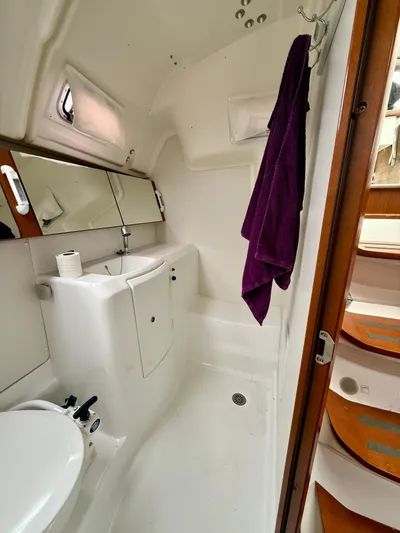  Yacht Photos Pics 2012 Beneteau Oceanis 37 yacht bathroom with mirror, sink, and purple towel.