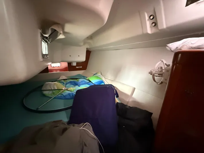  Yacht Photos Pics Interior cabin of 2012 Beneteau Oceanis 37 sailboat with bedding and storage.