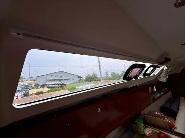  Yacht Photos Pics Interior view of a 2012 Beneteau Oceanis 37 sailboat, showcasing cabin window and storage.