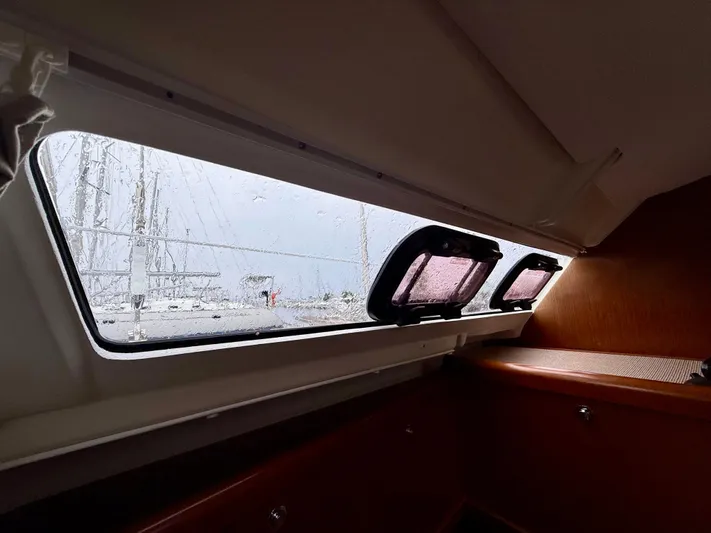  Yacht Photos Pics Interior view of 2012 Beneteau Oceanis 37 sailboat cabin with rain on window.