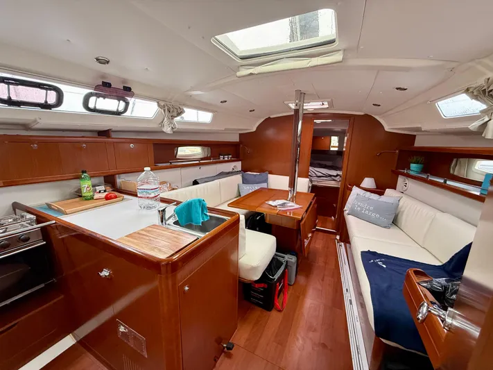  Yacht Photos Pics Interior of 2012 Beneteau Oceanis 37 sailboat with cozy seating and modern kitchen.