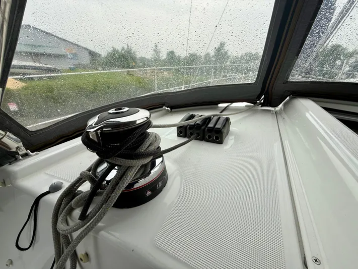  Yacht Photos Pics Beneteau Oceanis 37 sailboat cockpit with winch and ropes, 2012 model, rainy day view.