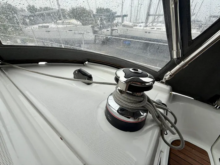 Yacht Photos Pics 2012 Beneteau Oceanis 37 sailboat deck with winch and rope in rainy marina.