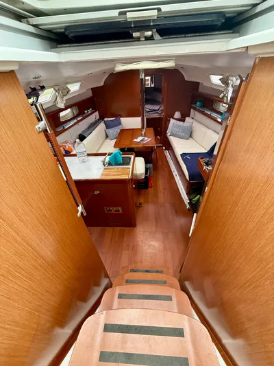 Yacht Photos Pics Interior of 2012 Beneteau Oceanis 37 sailboat with wooden finish and seating area.