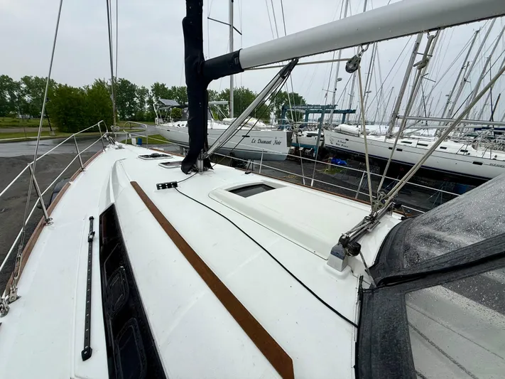  Yacht Photos Pics 2012 Beneteau Oceanis 37 sailboat deck view, docked with other boats.