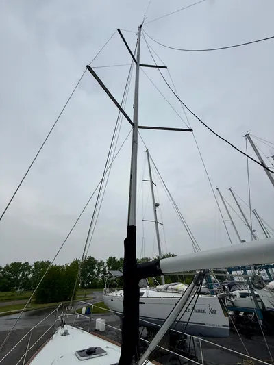  Yacht Photos Pics Beneteau Oceanis 37 sailboat mast, 2012 model, docked with overcast sky.