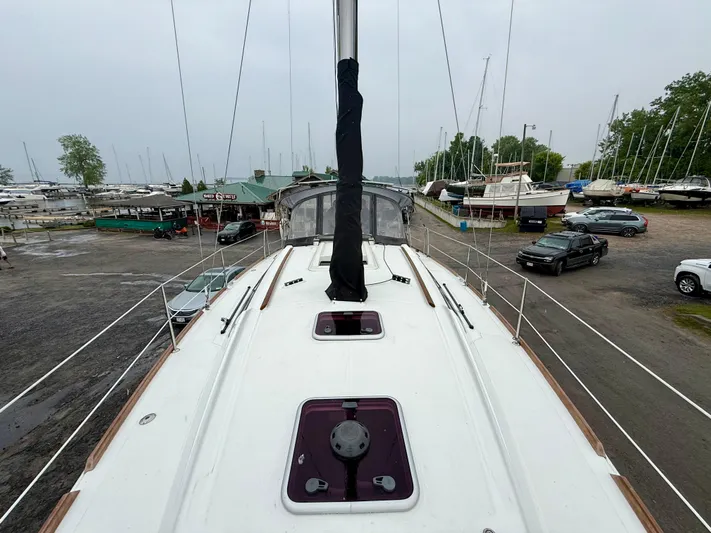  Yacht Photos Pics 2012 Beneteau Oceanis 37 sailboat on land, marina background, overcast sky.