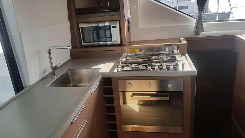 Skye Yacht Photos Pics Modern kitchen in 2023 Lagoon 50 yacht with stove, sink, and microwave.