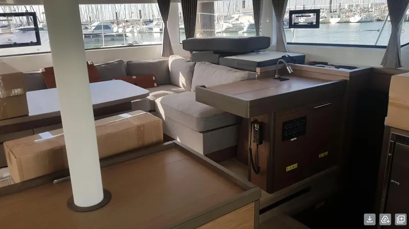 Skye Yacht Photos Pics Interior of 2023 Lagoon 50 yacht with modern furnishings and marina view.
