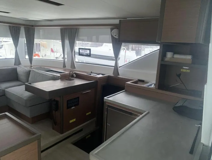Skye Yacht Photos Pics Interior of 2023 Lagoon 50 yacht with modern kitchen and seating area.