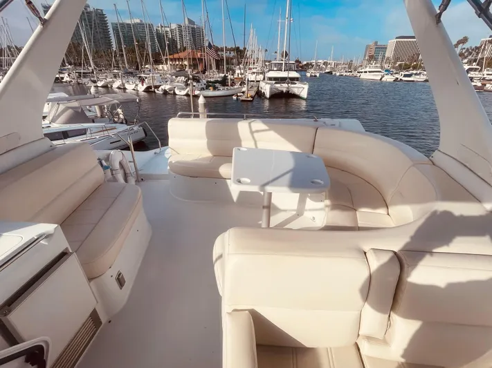  Yacht Photos Pics Luxurious 1999 Carver Voyager yacht interior with plush seating, docked at a marina.