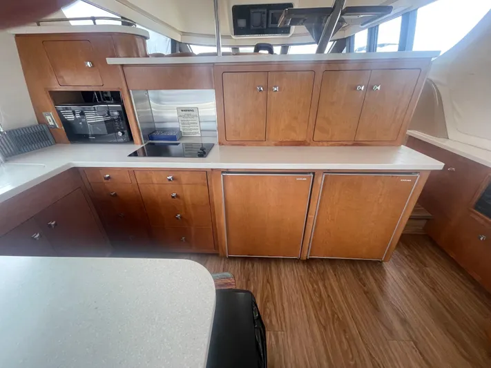  Yacht Photos Pics Interior of a 1999 Carver Voyager yacht kitchen with wooden cabinets and modern appliances.