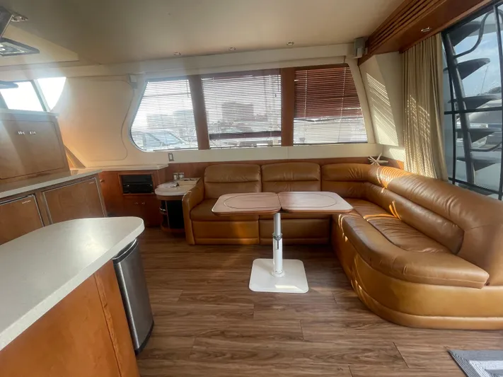  Yacht Photos Pics Luxurious interior of 1999 Carver Voyager yacht with leather seating and wooden flooring.