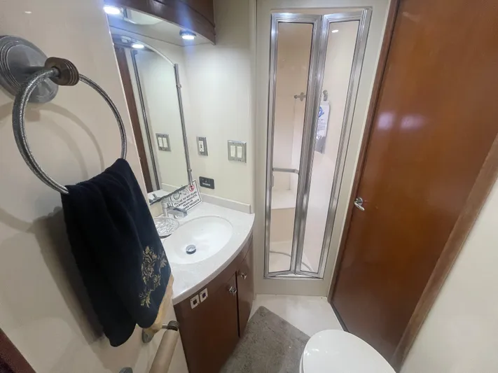  Yacht Photos Pics Bathroom interior of 1999 Carver Voyager yacht with shower, sink, and towel rack.