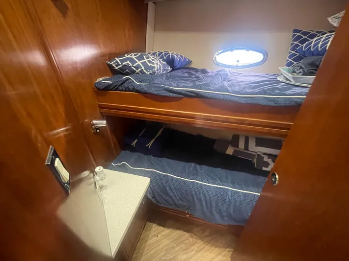  Yacht Photos Pics 1999 Carver Voyager cabin with wooden interior, bunk beds, and a small window.