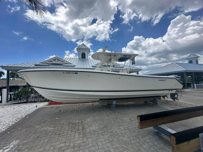  Yacht Photos Pics 2009 Pursuit C 310 Center Console boat on display under a cloudy sky.