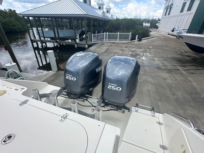  Yacht Photos Pics 2009 Pursuit C 310 Center Console with twin Yamaha 250 engines at a marina dock.