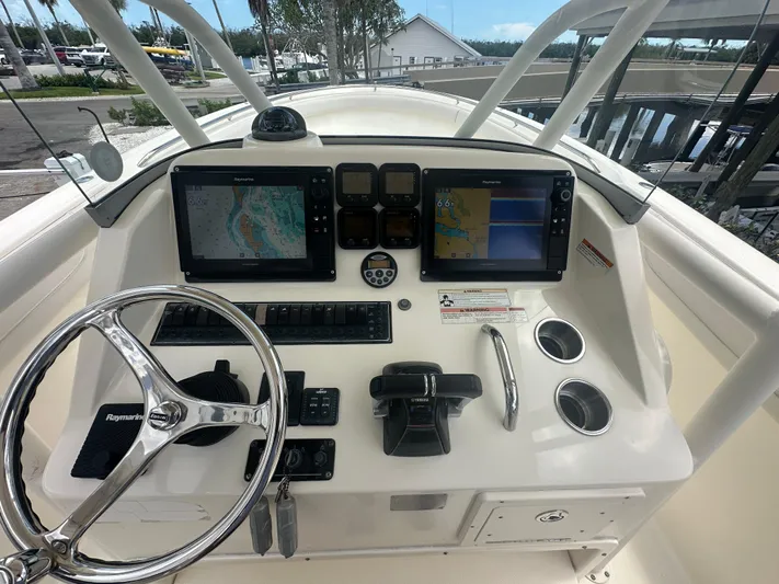  Yacht Photos Pics 2009 Pursuit C 310 Center Console boat dashboard with navigation screens and controls.