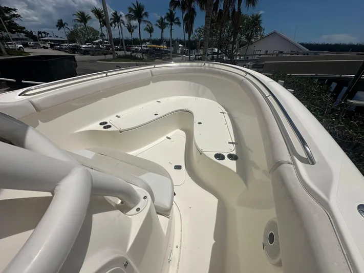  Yacht Photos Pics 2009 Pursuit C 310 Center Console boat interior with seating and cup holders, surrounded by palm trees.