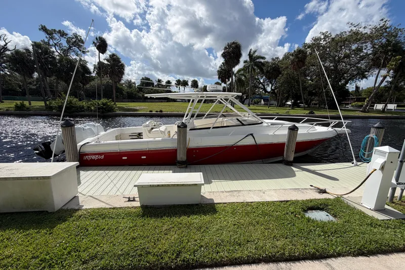 Watch Me Yacht Photos Pics 2008 Intrepid 350 Center Console boat docked by a scenic waterfront.