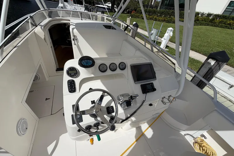 Watch Me Yacht Photos Pics 2008 Intrepid 350 Center Console boat cockpit with steering wheel and navigation instruments.