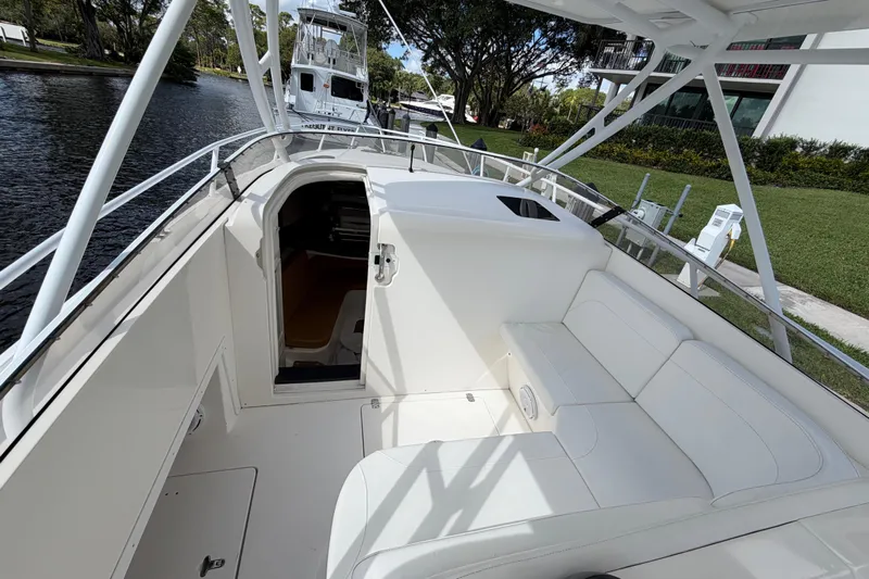 Watch Me Yacht Photos Pics 2008 Intrepid 350 Center Console boat interior with white seating and open cabin door.