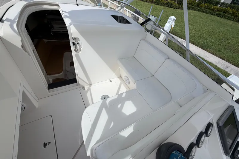 Watch Me Yacht Photos Pics 2008 Intrepid 350 Center Console boat interior with white seating and open cabin door.