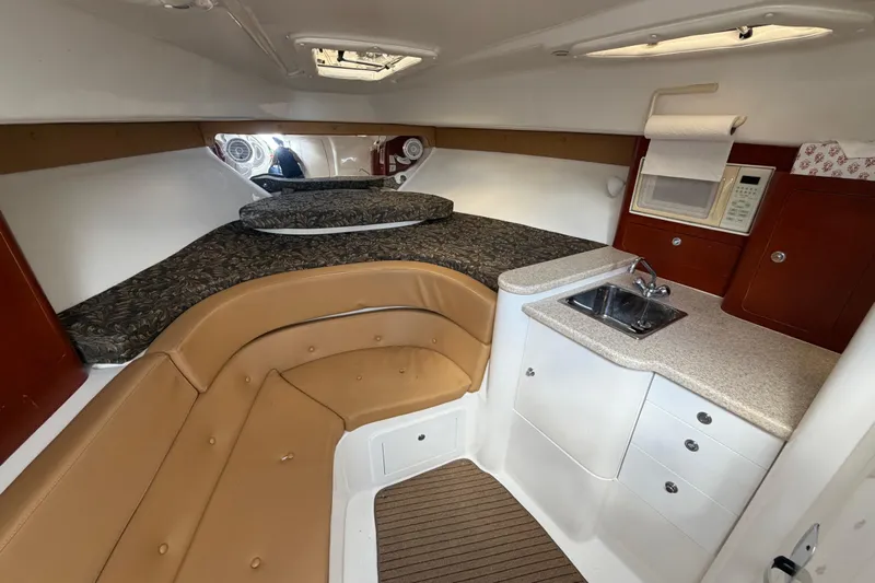 Watch Me Yacht Photos Pics Interior of 2008 Intrepid 350 Center Console with bed, kitchenette, and seating area.