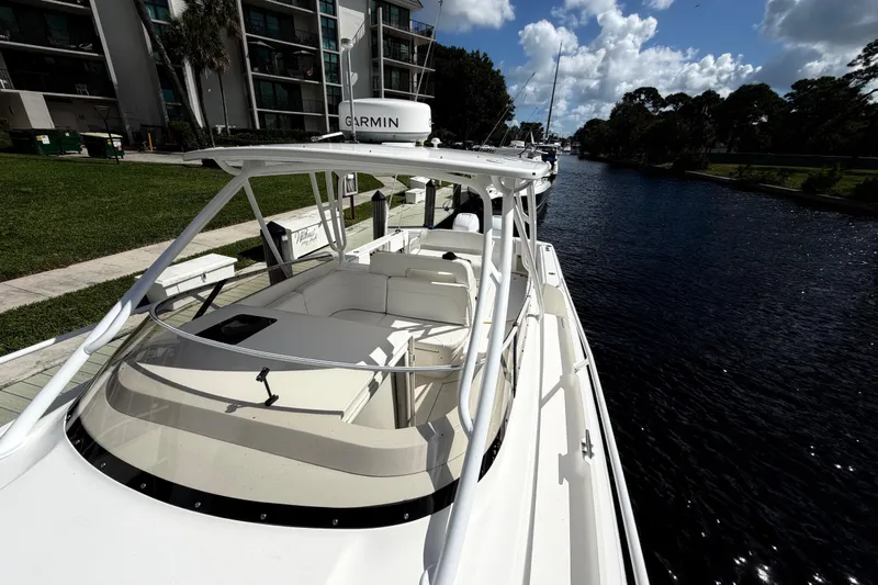 Watch Me Yacht Photos Pics 2008 Intrepid 350 Center Console boat docked by a canal under a sunny sky.