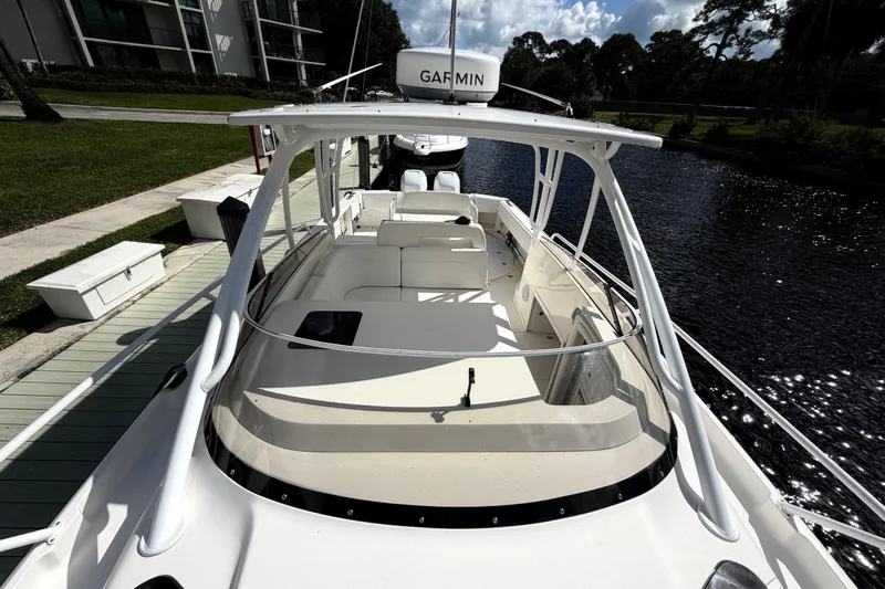 Watch Me Yacht Photos Pics 2008 Intrepid 350 Center Console boat docked by a serene waterfront.