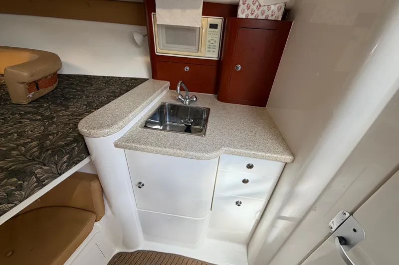 Watch Me Yacht Photos Pics 2008 Intrepid 350 Center Console cabin with sink, microwave, and storage cabinets.