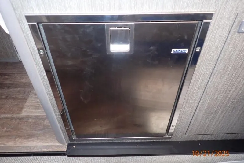  Yacht Photos Pics Stainless steel door inside 2021 Monterey 295 Sport Yacht, featuring modern design and wood flooring.