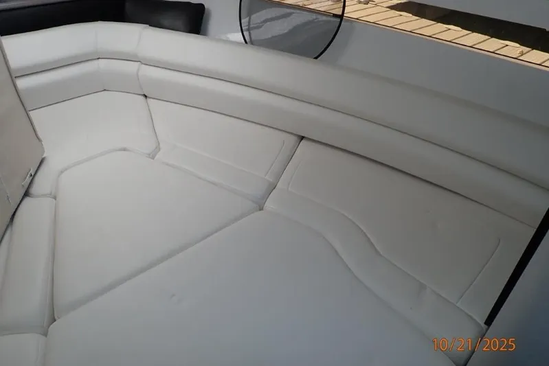  Yacht Photos Pics Interior seating of 2021 Monterey 295 Sport Yacht, featuring white cushioned upholstery.