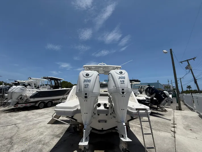 317-125 Yacht Photos Pics 2024 Robalo R317 Dual Console boat with twin Yamaha 300 V6 engines, parked outdoors.