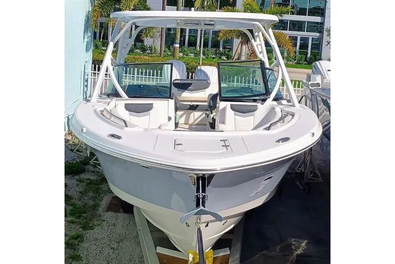317-125 Yacht Photos Pics 2024 Robalo R317 Dual Console boat, docked outdoors, showcasing sleek design and spacious seating.