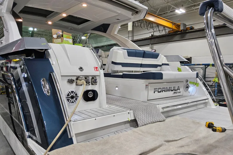  Yacht Photos Pics 2026 Formula 380 Super Sport Crossover OB in a workshop, showcasing luxury seating and design.